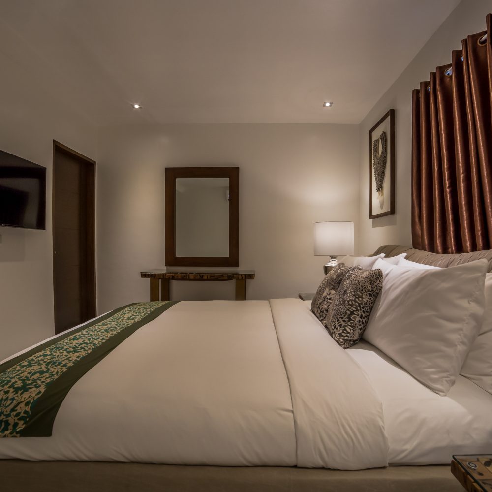The bedroom flaunts a king-sized bed and ample space for your stay.
