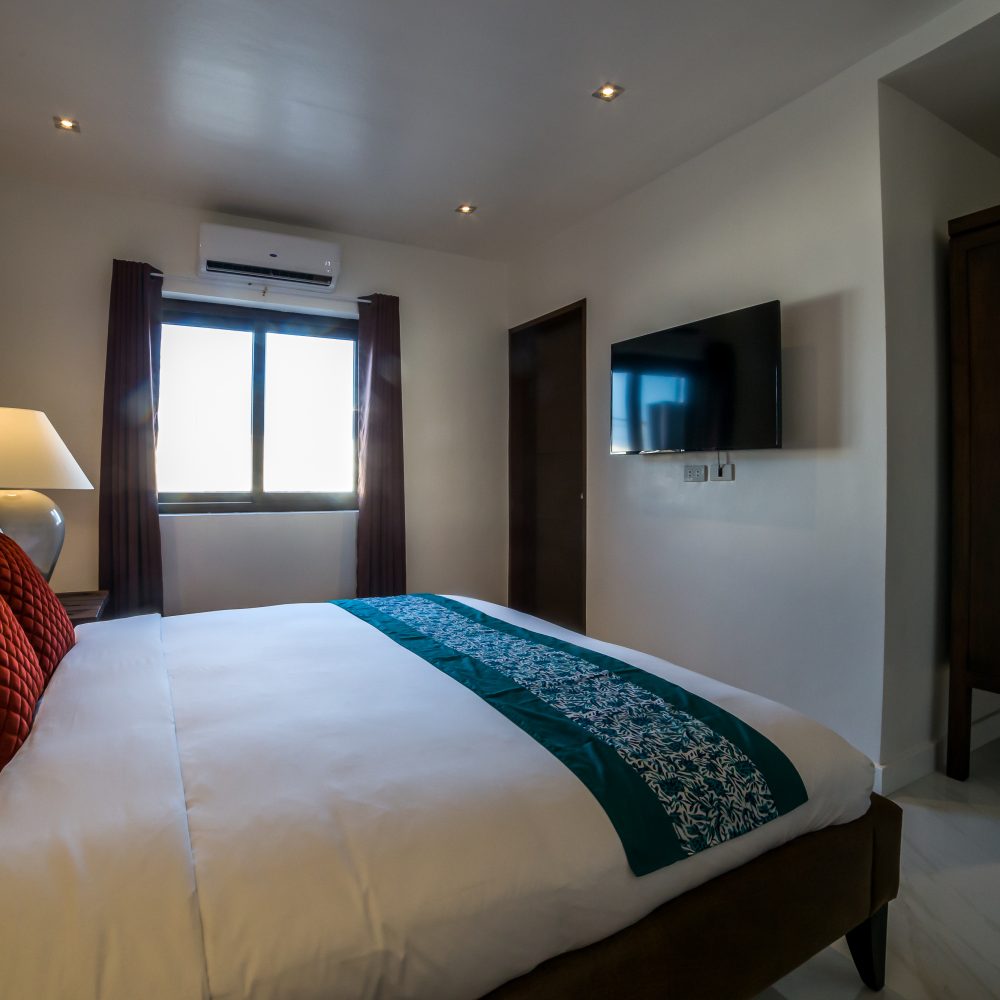 The bedroom flaunts a king-sized bed and ample space for your stay.